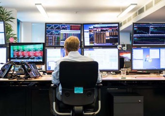 Man in front of monitors